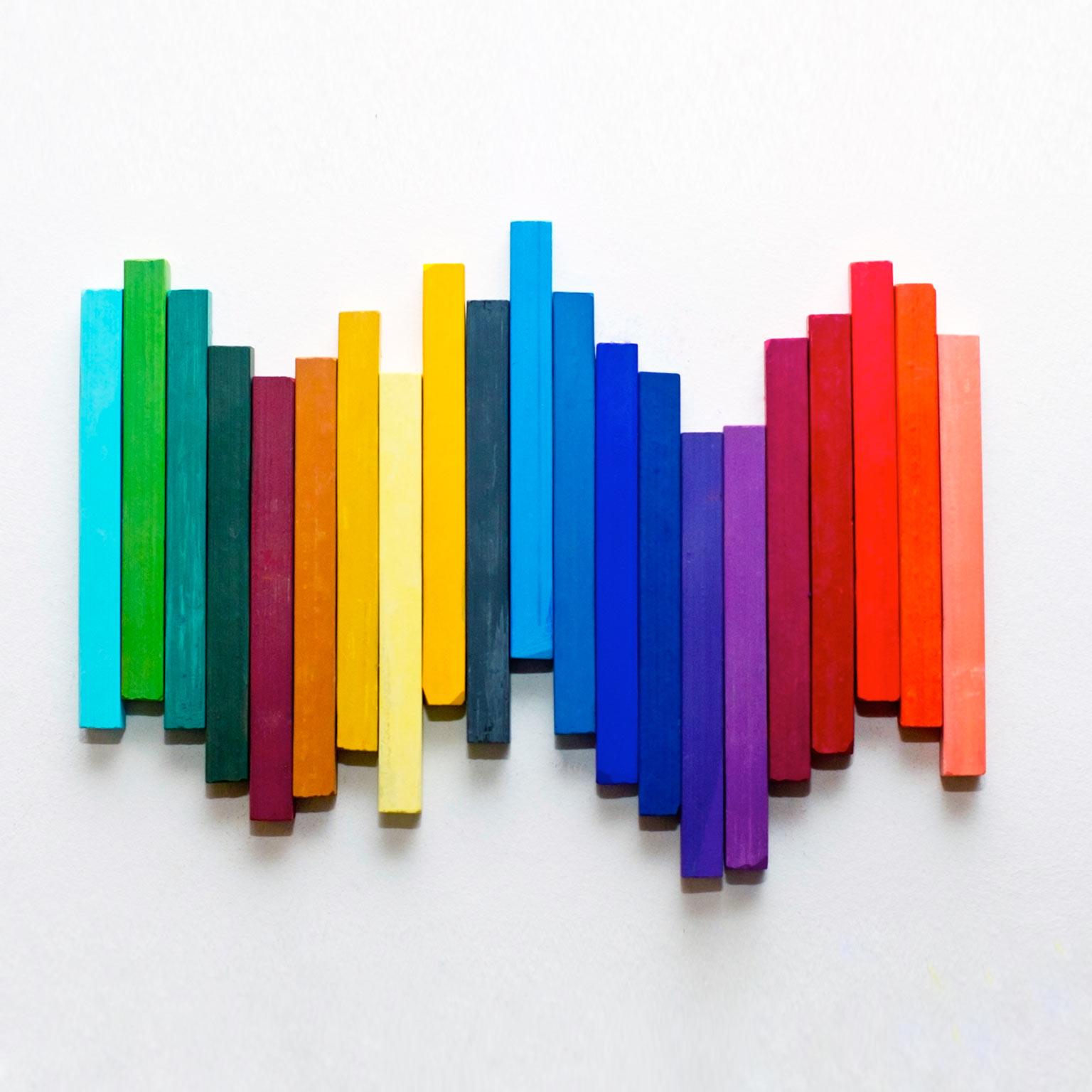 two people sitting on a ledge talking